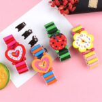 3-piece wooden bracelet watch for children on pink background with white leaf