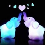 Children's elephant nightlight with colored light on black background