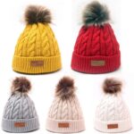 Knitted hat with fur pompon