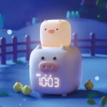 Voice-controlled LED pig alarm clock in a farmhouse at night