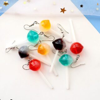 Colorful lollipop earrings on a white and blue background
