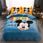 Comforter cover with Mickey print for a child in a bedroom in front of a window