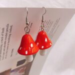 Red and white mushroom on a leaf pendant earrings