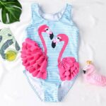 One-piece pink flamingo swimsuit with white and blue stripes on a white background