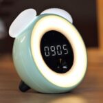 Smart green and white children's digital alarm clock on a wooden table