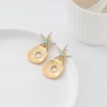 Gold starfish earring in a white plate