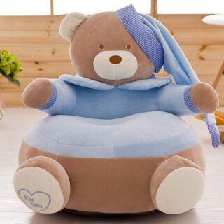Brown and blue teddy bear pouffe with pyjamas in hallway