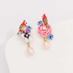 Vintage earring with colorful flowers and birds on a white background