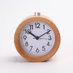 Wooden children's alarm clock with white background