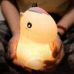 Children's bedside lamp in the shape of a luminous unicorn with black eyes