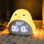 Yellow bird alarm clock with black eyes and orange nose