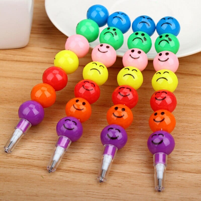 20 pieces of colorful 3D smiley pencils on a wooden table