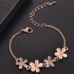 Small cat's eye flower bracelet for pink children with chain on black background