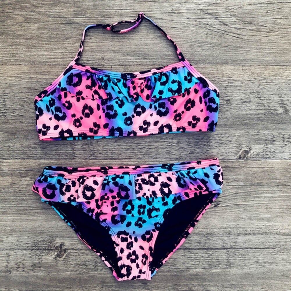 2-piece leopard print swimsuit for girls in pink, purple and blue on grey wood