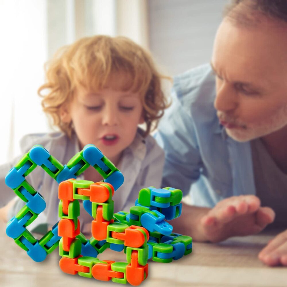 Green, blue and orange children's plastic rotation puzzle with child and father in a lounge to play on a table