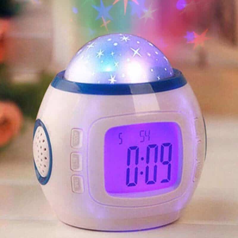 LED alarm clock with multicolored starlight and digital front on wooden tabletop