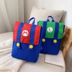 Super Mario backpack for kids red and blue, green and blue on a bed with a cushion