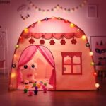 Pink prince or princess tepee house with stuffed animals inside and lights