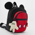 Red and black backpack with white Mickey paw