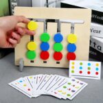 Wooden children's game with coloured pieces and cards on a grey table