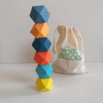 Geometric wooden balance tower with white bag