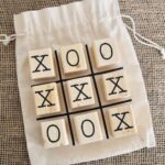 Wooden Tic Tac Toe with cross and ball with white bag