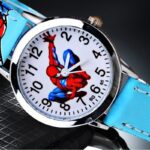 Quartz watch with turquoise and silver Spiderman motif on black background with spider man motif