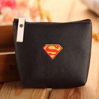 Coin purse with Superman logo in black on a wooden base