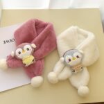 White and burgundy soft plush scarf for children on a table