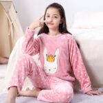 A girl wearing polar pyjamas with a white bunny pattern in bed