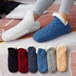 Warm and colorful children's thick wool winter socks in a girl's feet
