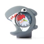 A plastic children's watch featuring a cute shark, with a glass dial in the center, colored hands inside, and printed shark teeth.