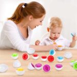 Smiling mom playing the egg game with her young blond son