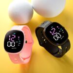 two colorful led watches for children, one in pink and the other in black